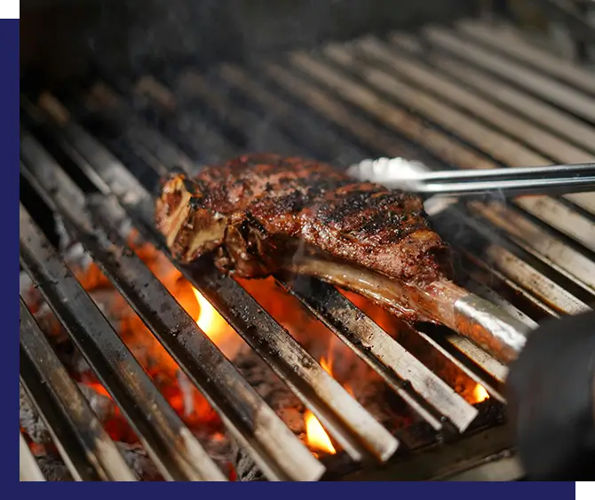 Meat cooking on a hot grill